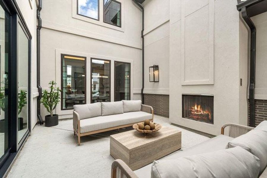 The stylish interior courtyard, equipped with an outdoor fireplace. Representative image.