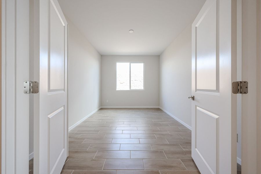 A hallway with white doors.