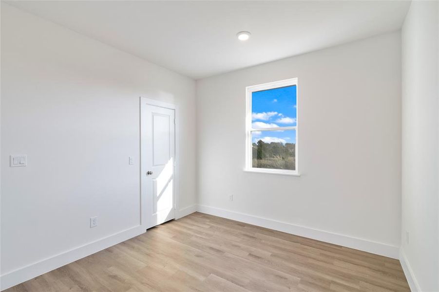 Empty room featuring light wood-type flooring