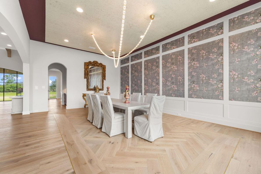Another view of formal dining room with unique rug design in hardwood floors framed by gold band which complement the crystal and gold accented light fixture. Another view of formal dining room with unique rug design in hardwood floors framed by gold band which complement the crystal and gold accented light fixture.
