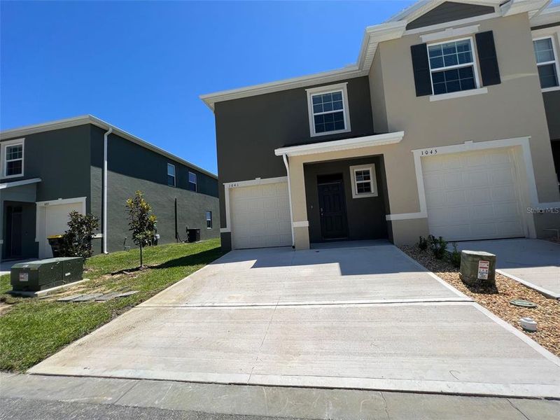 Front exterior of a new home in , Davenport, FL, highlighting curb appeal (Image 1).