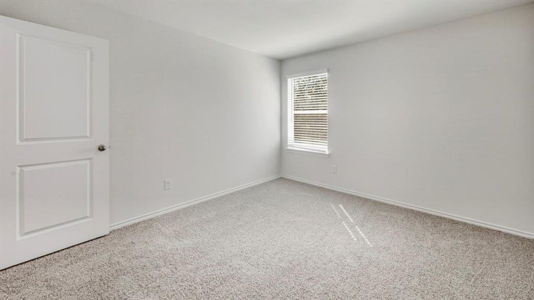 Unfurnished room with carpet and baseboards