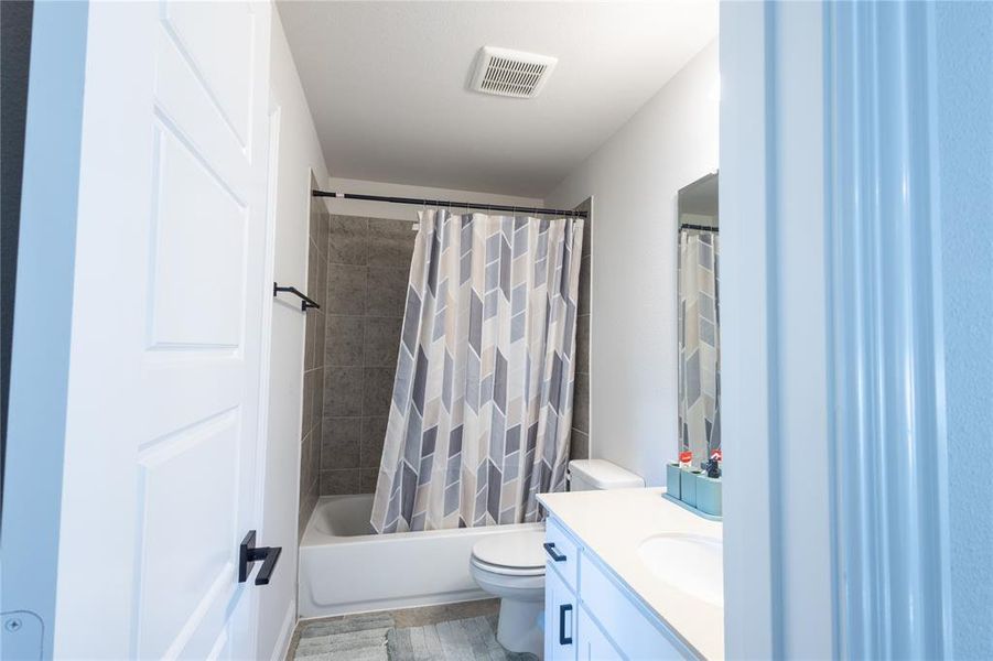 Bathroom featuring shower / tub combo and vanity