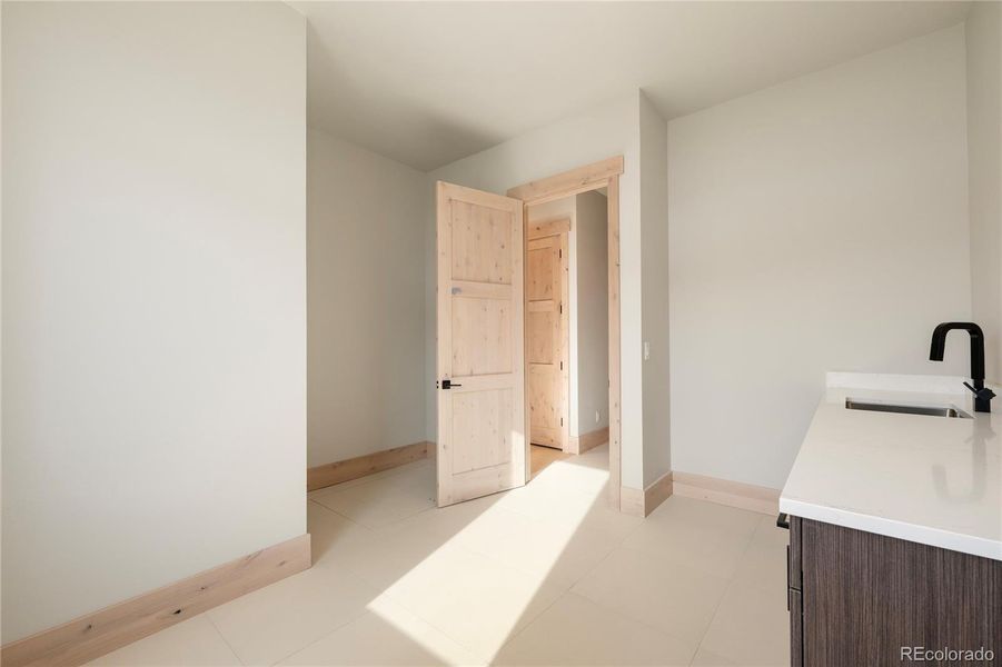 Main level laundry room with sink