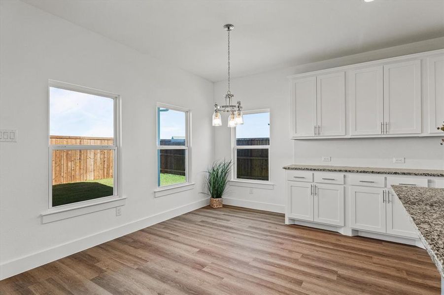 dining area featuring light hardwood / wood-style floors and an inviting chandelier