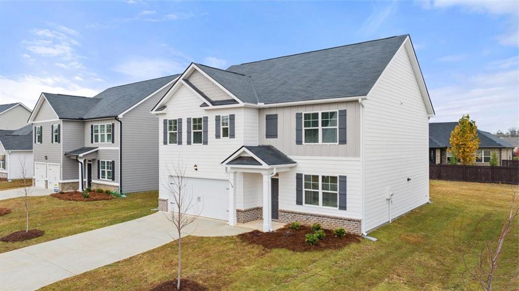 Front exterior of a new home in Champion's Run, Lithonia, GA, highlighting curb appeal (Image 18). Front exterior of a new home in Champion's Run, Lithonia, GA, highlighting curb appeal (Image 18).