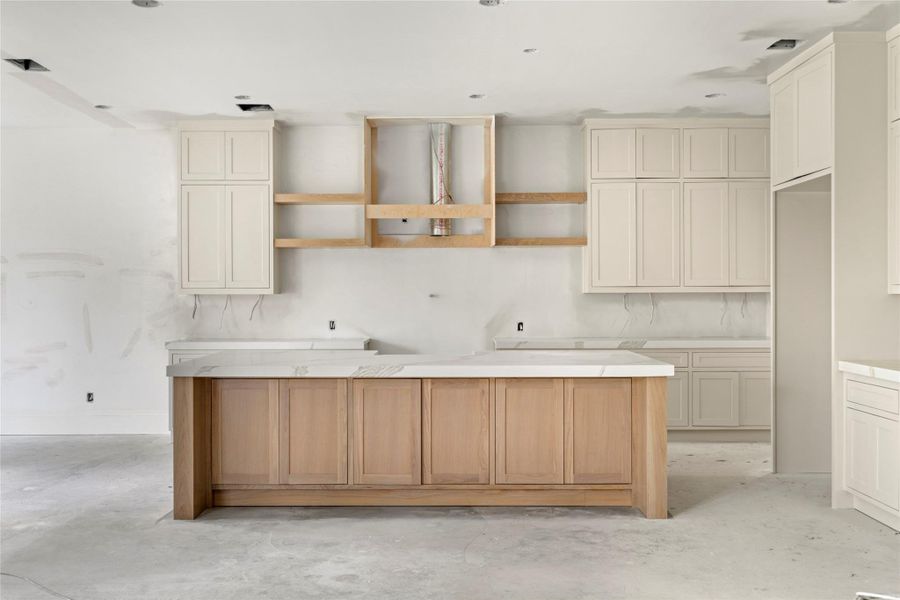 Kitchen has all custom built cabinetry. Ample amount of storage with an expansive island with a lip for counter seating as well. Kitchen has all custom built cabinetry. Ample amount of storage with an expansive island with a lip for counter seating as well.