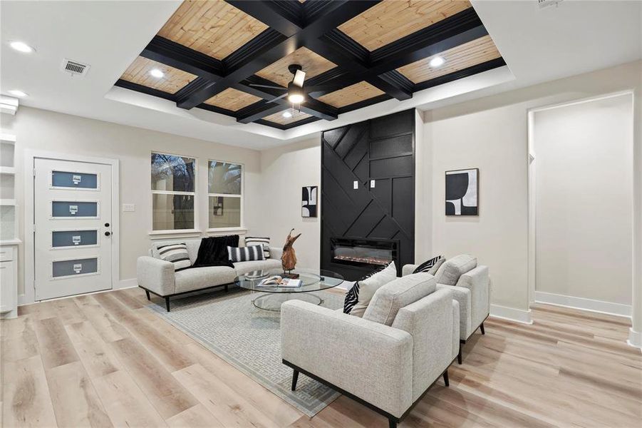Living area featuring coffered ceiling, light wood-type flooring, a fireplace, recessed lighting, and wooden ceiling Living area featuring coffered ceiling, light wood-type flooring, a fireplace, recessed lighting, and wooden ceiling