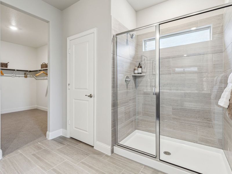 Primary bathroom with double vanity and large walk-in closet Primary bathroom with double vanity and large walk-in closet