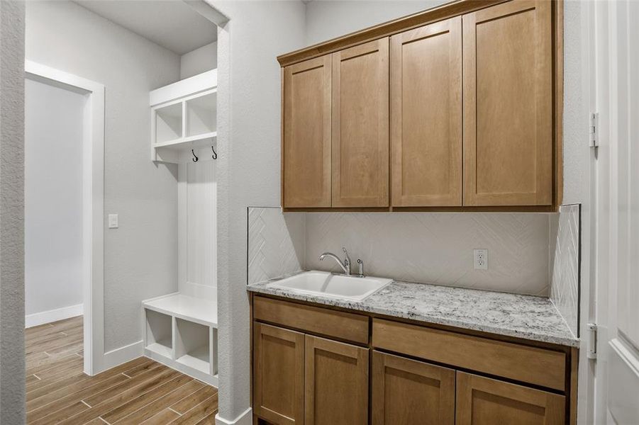 Mudroom featuring wood tiled floors and baseboards