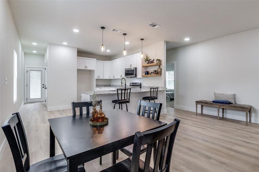 Dining space featuring light hardwood / wood-style flooring and sink