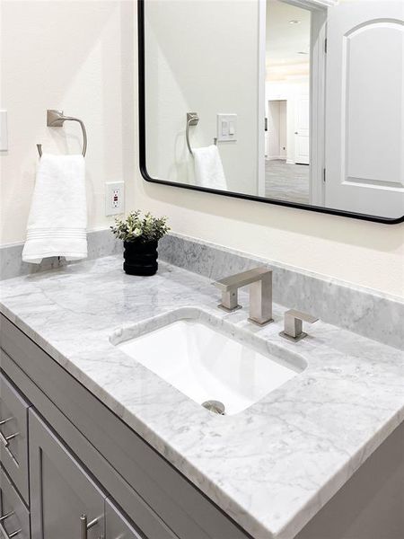 Bathroom featuring vanity with extensive cabinet space