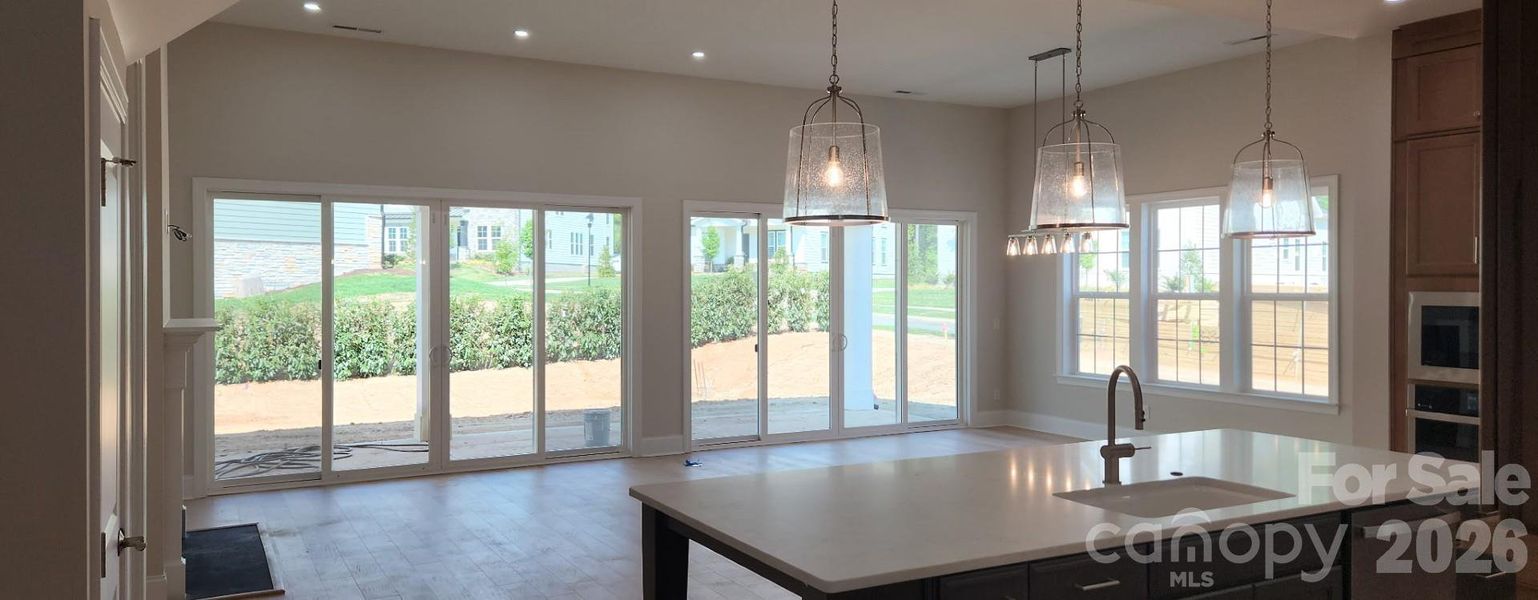 Light-Filled Great Room with 2 sets of 12' Sliding Doors, opening to a large covered patio
