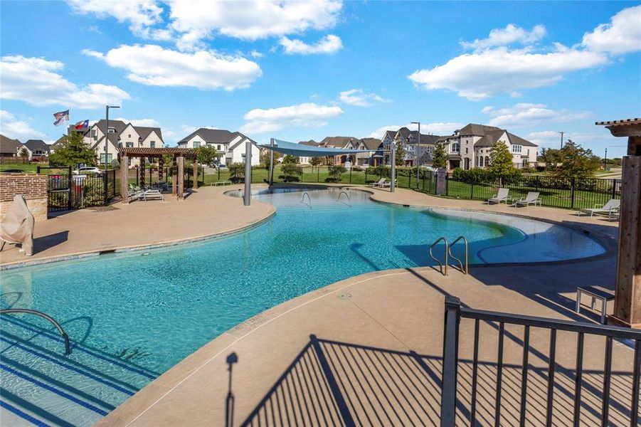 Community pool with a residential view, a pergola, and a patio area