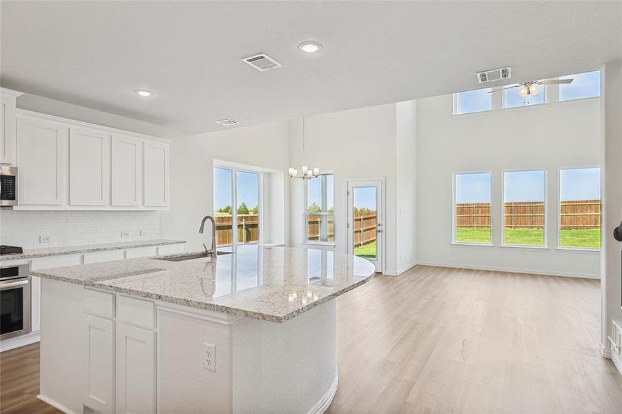 Kitchen with a wealth of natural light, appliances with stainless steel finishes, and white cabinetry