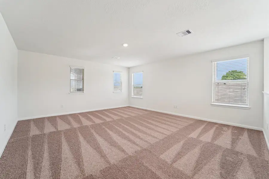 This spacious game room is the ultimate destination for fun. With plenty of room a friendly competition around the pool table to movie marathons, this incredible game room is where unforgettable memories are made. Featuring plush carpet flooring, plenty of windows for natural lighting, neutral toned walls, and recessed lighting.