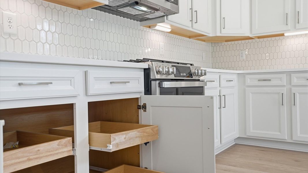 Well-designed kitchen with ample storage and tasteful finishes that elevate everyday living by DRB Homes