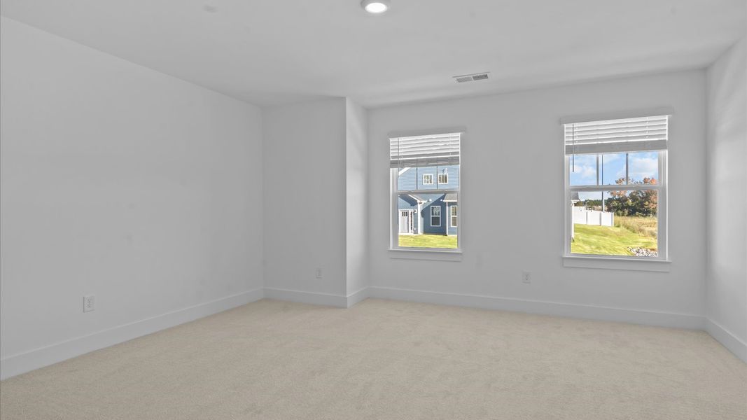 First-class bedroom with generous proportions, a walk-in closet, and beautiful natural light through large windows
