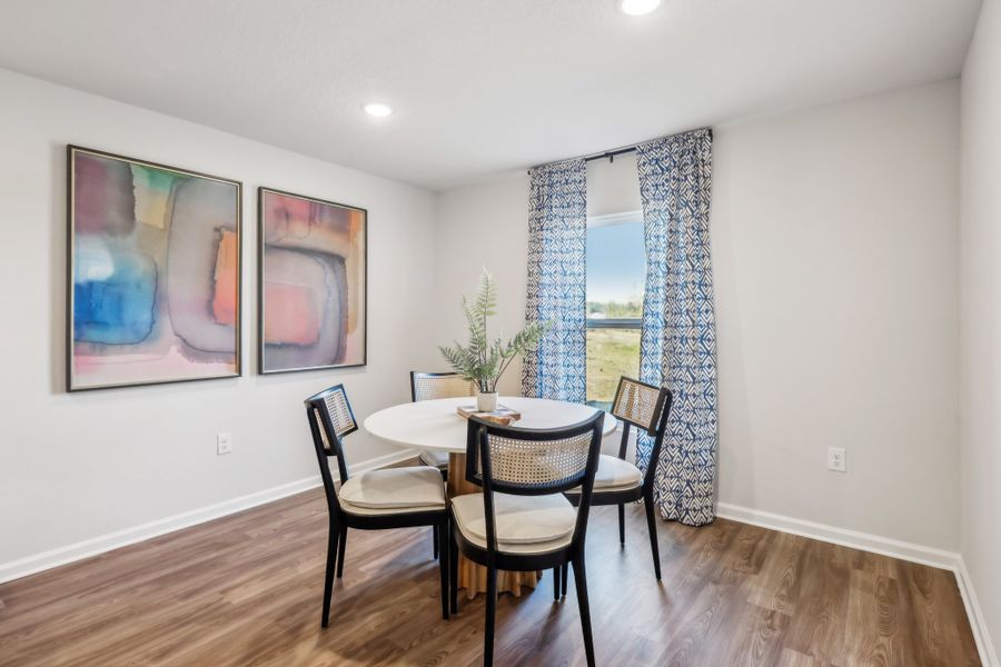 A dining room with a table and chairs. A dining room with a table and chairs.
