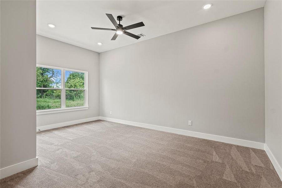 Carpeted spare room with recessed lighting and a ceiling fan