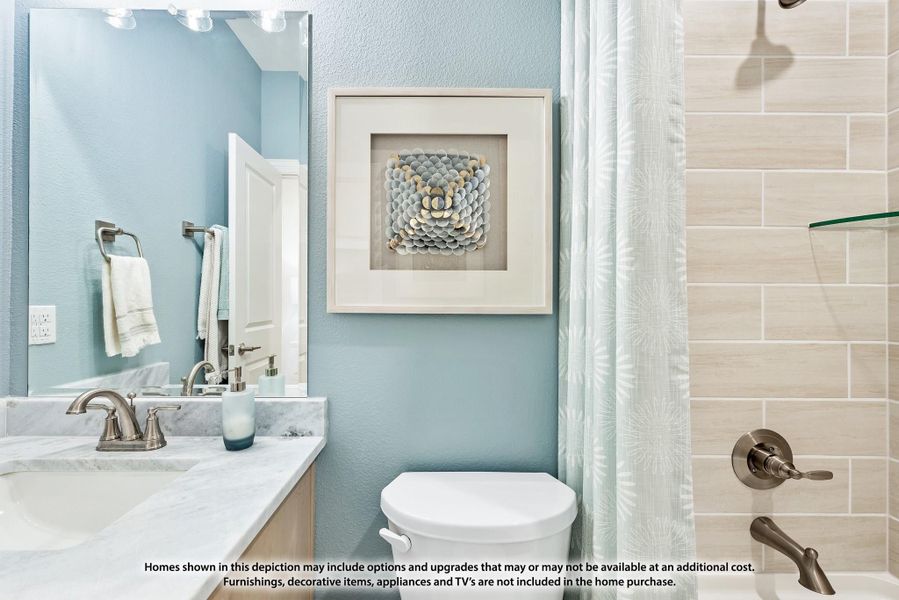 Bathroom with marble vanity, large mirror, and tiled shower with curtain on blue walls Bathroom with marble vanity, large mirror, and tiled shower with curtain on blue walls