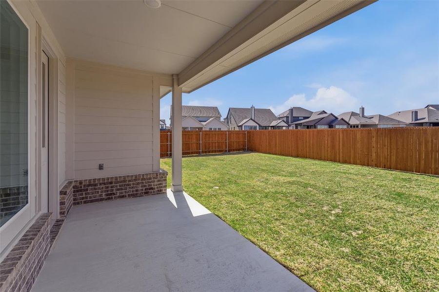 Fenced backyard featuring a patio and a residential view