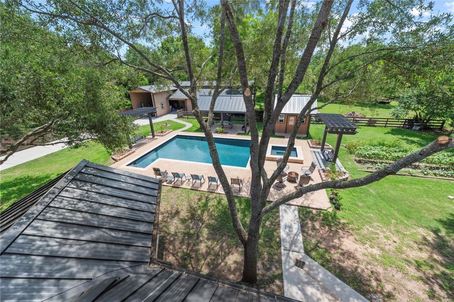 Sweeping aerial perspective highlighting the luxury pool, manicured acreage, and exceptional outdoor living spaces.