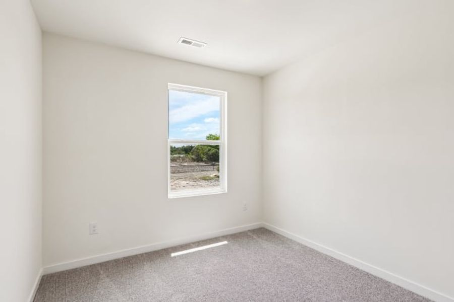 A room with a window and a view of the ocean.
