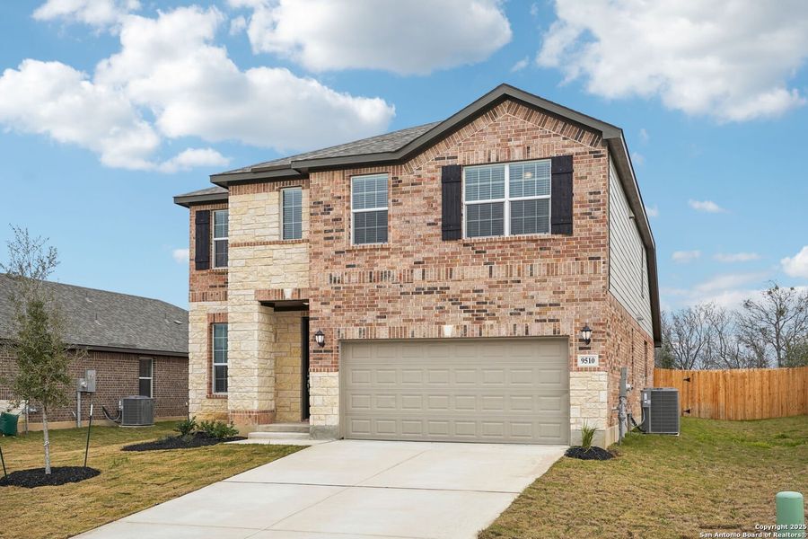Front exterior of a new home in Carmel Ranch, Schertz, TX, highlighting curb appeal (Image 1).
