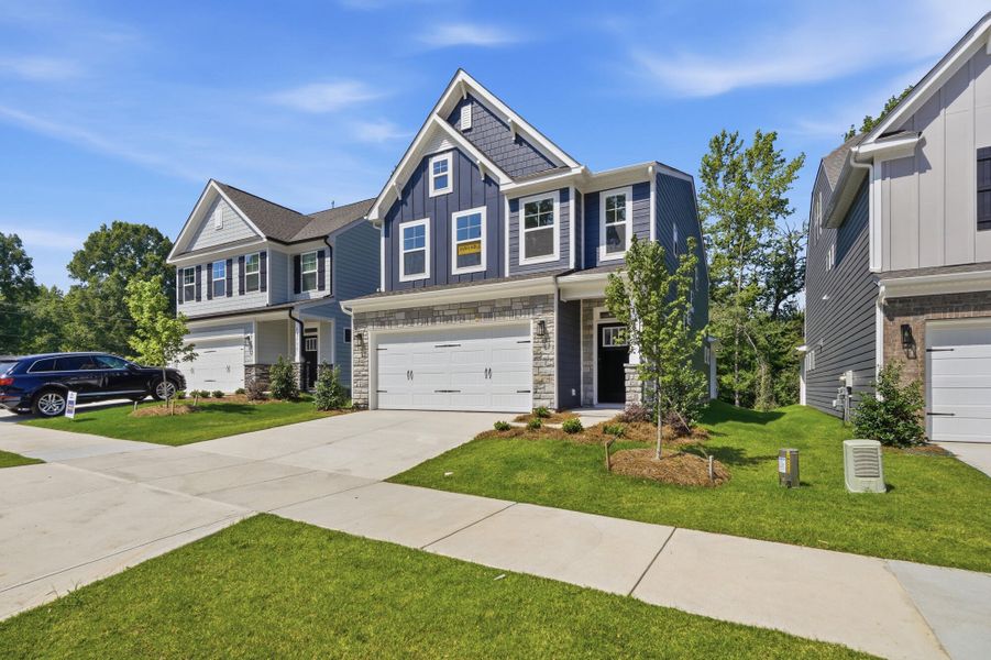 Front exterior of a new home in Caldwell Forest, Charlotte, NC, highlighting curb appeal (Image 24). Front exterior of a new home in Caldwell Forest, Charlotte, NC, highlighting curb appeal (Image 24).