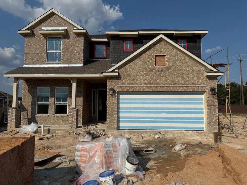 Front exterior of a new home in The Trails, New Caney, TX, highlighting curb appeal (Image 2). Front exterior of a new home in The Trails, New Caney, TX, highlighting curb appeal (Image 2).