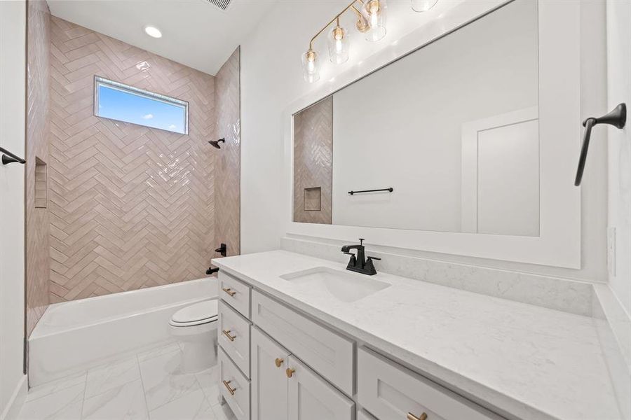 Full bath featuring vanity, shower combination, light marble finish floors, and recessed lighting Full bath featuring vanity, shower combination, light marble finish floors, and recessed lighting