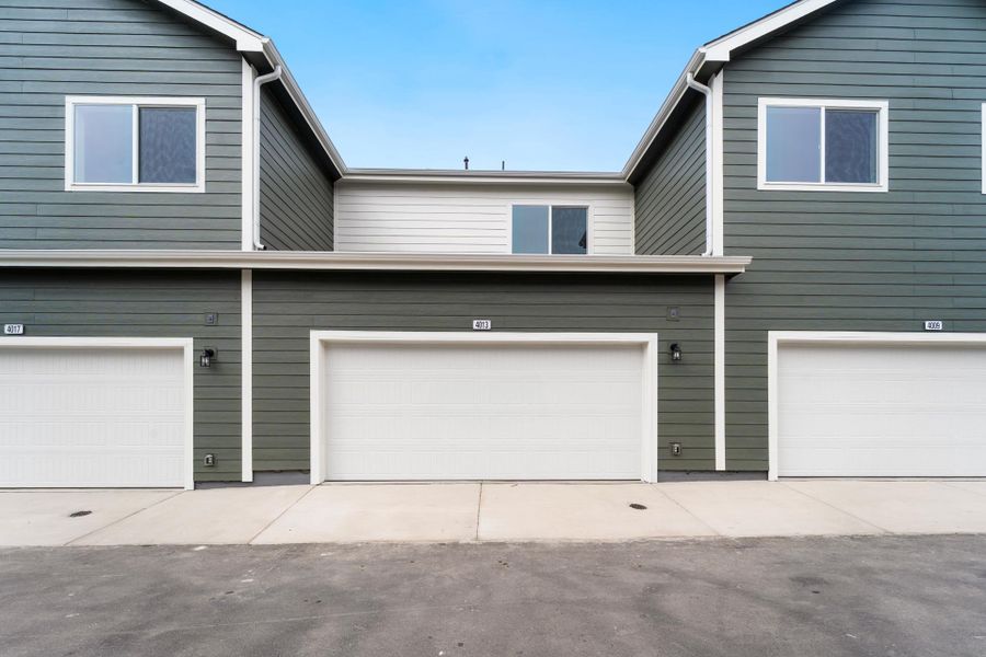 Front exterior of a new home in Liberty Draw, Evans, CO, highlighting curb appeal (Image 17).