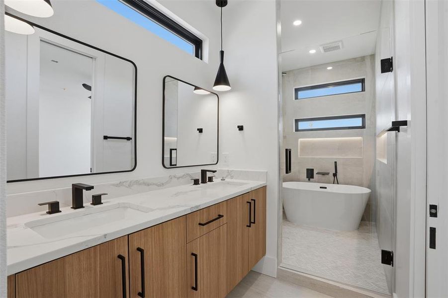Primary bathroom with dual sinks and spa-like shower/soaking tub