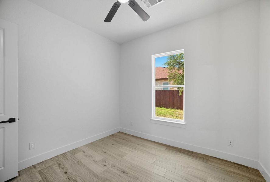 Spare room featuring light wood-style floors and ceiling fan Spare room featuring light wood-style floors and ceiling fan