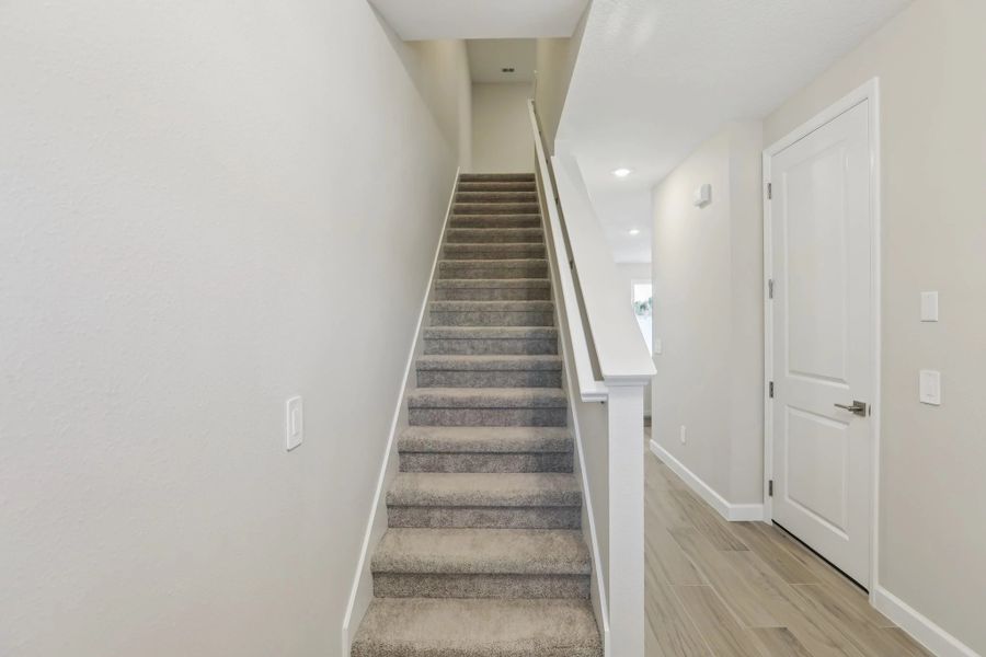 Staircase to second floor located at the front of the home