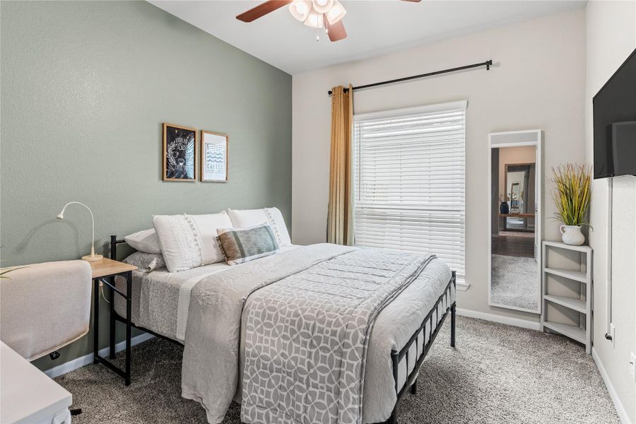 A comfortable bedroom with a warm, inviting atmosphere and ample natural light. A comfortable bedroom with a warm, inviting atmosphere and ample natural light.