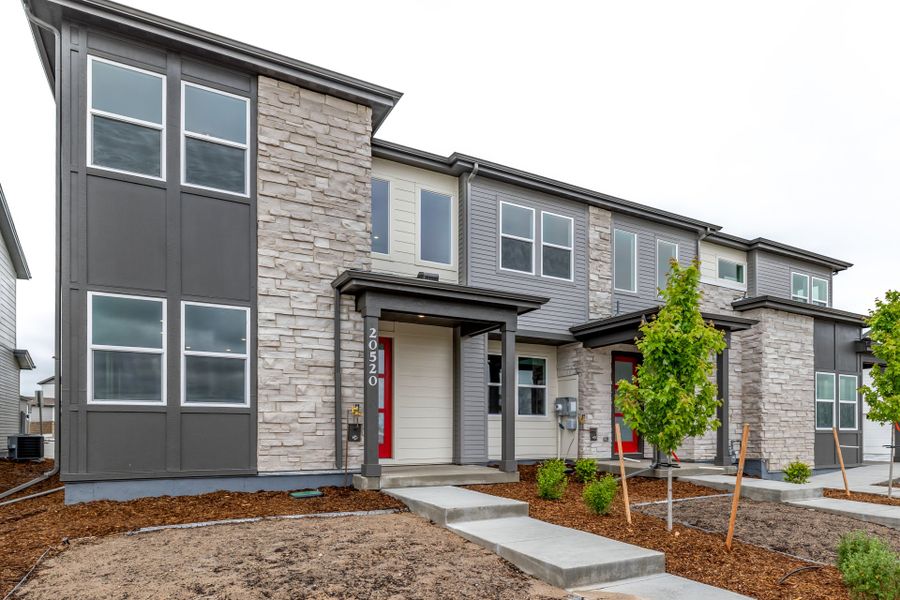 Front exterior of a new home in Painted Prairie, Aurora, CO, highlighting curb appeal (Image 20).
