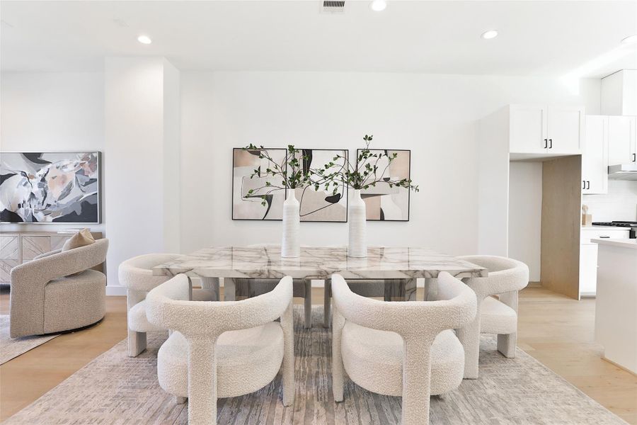 Picture yourself dining with friends and family in this spacious, open second-floor living area. To the right, a dry bar with ample storage is perfect for your decor, dishes, and more.