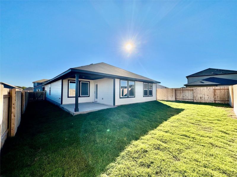 Rear view of house with a fenced backyard and a patio area Rear view of house with a fenced backyard and a patio area