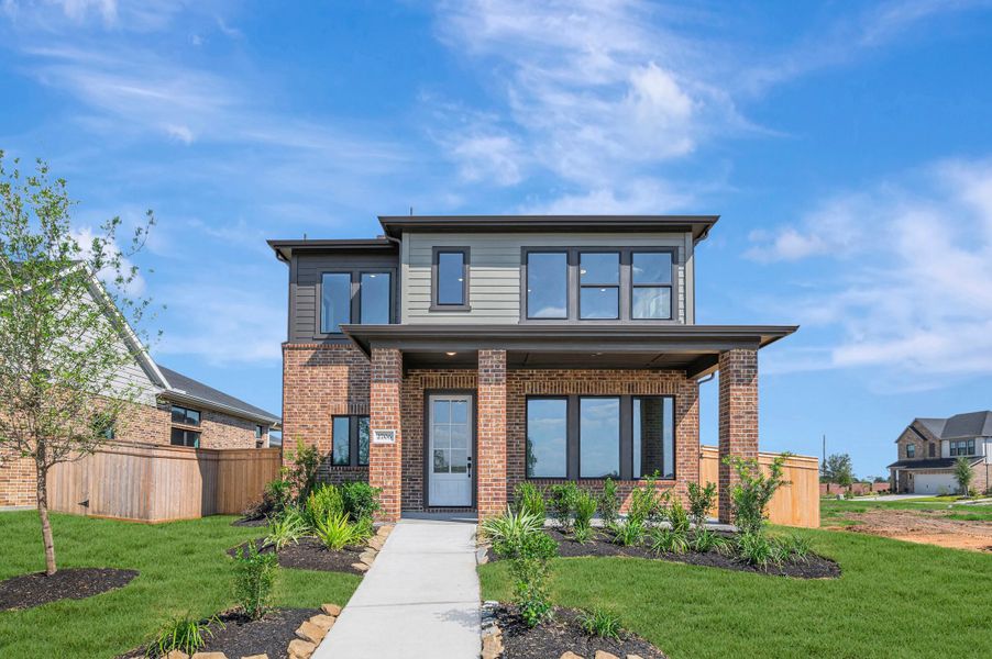 Front exterior of a new home in Sienna - Landmark Row Collection, Missouri City, TX, highlighting curb appeal (Image 2). Front exterior of a new home in Sienna - Landmark Row Collection, Missouri City, TX, highlighting curb appeal (Image 2).