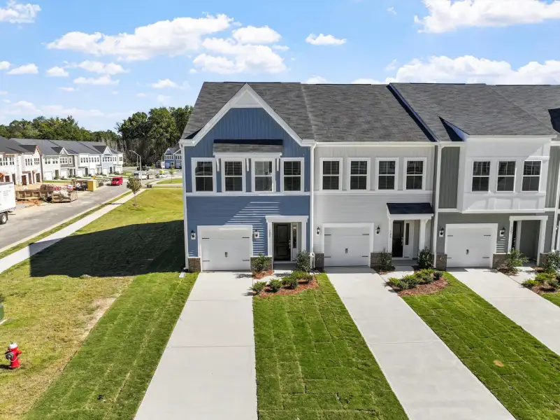 Front exterior of a new home in West Main Townhomes, Sanford, NC, highlighting curb appeal (Image 1). Front exterior of a new home in West Main Townhomes, Sanford, NC, highlighting curb appeal (Image 1).