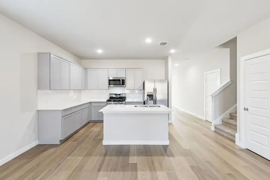 Kitchen in the Haylee home plan by Trophy Signature Homes - REPRESENTATIVE PHOTO