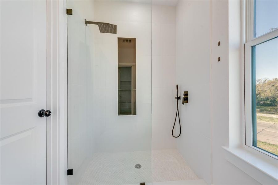 Bathroom featuring a tile shower