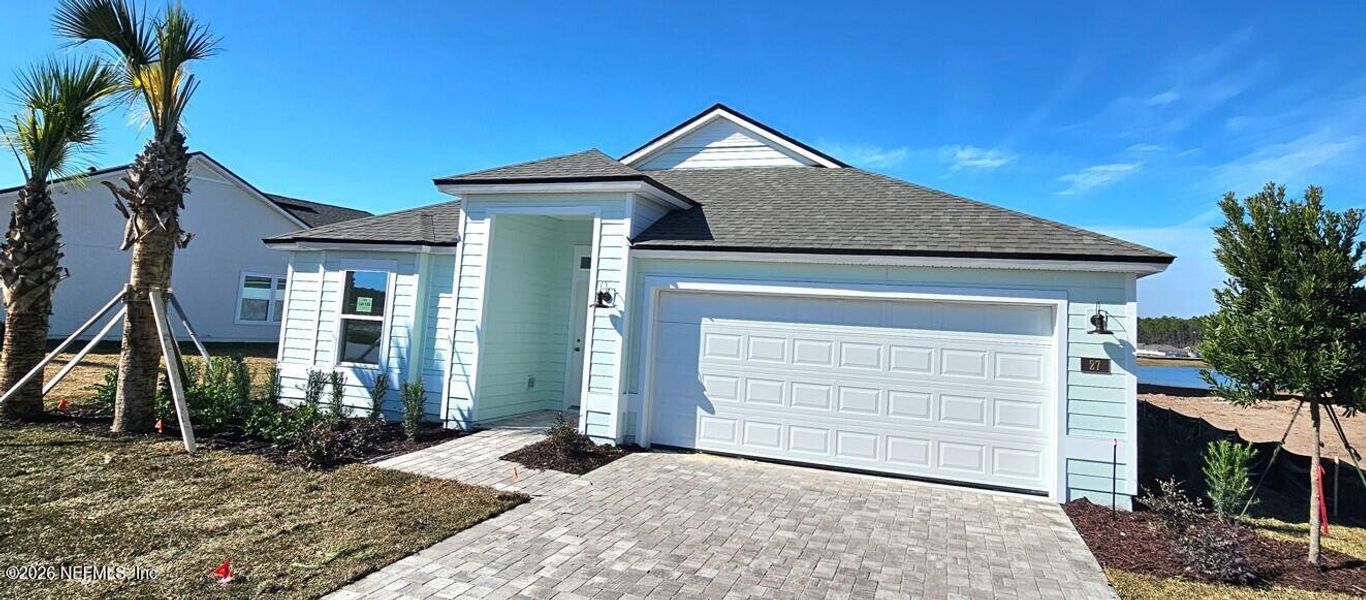 Front exterior of a new home in Sawmill Branch, Palm Coast, FL, highlighting curb appeal (Image 2).