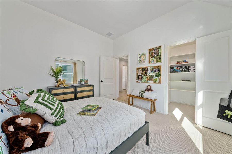 Carpeted bedroom with vaulted ceiling