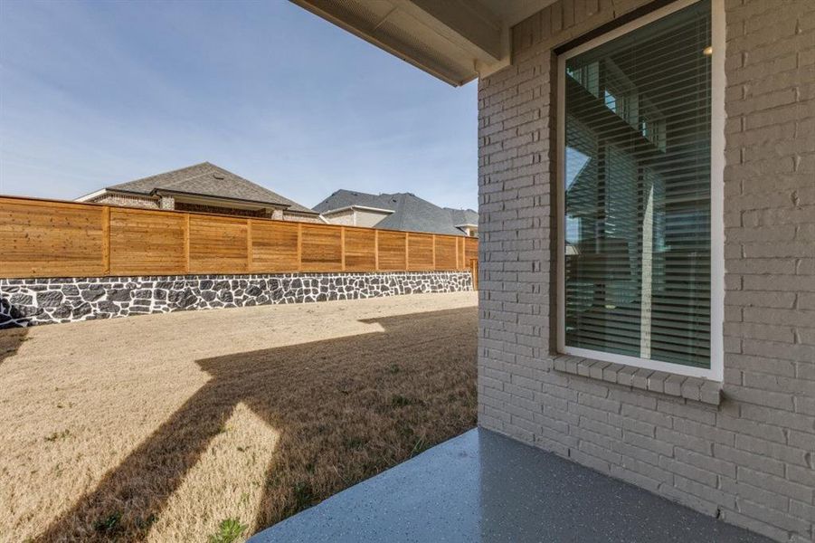 Fenced backyard with a patio area