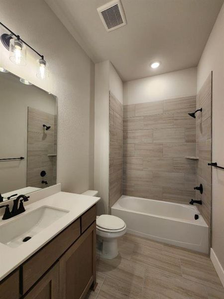 Bathroom featuring a single vanity with wood-finish cabinetry and a white countertop