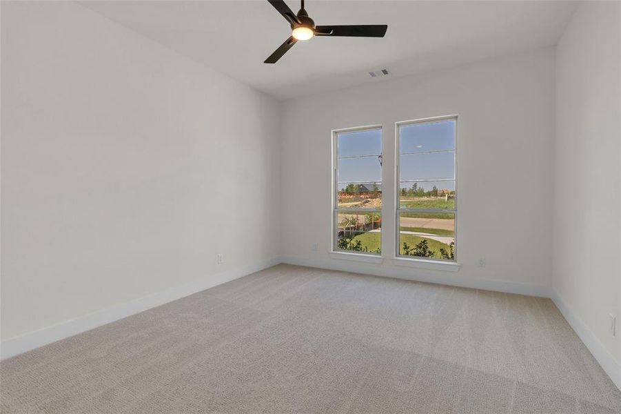 Room featuring light-toned carpeting, white walls, and bright trim work