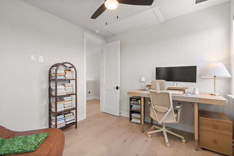 An airy office space offers hardwood flooring and an integrated ceiling fan for optimal comfort. An airy office space offers hardwood flooring and an integrated ceiling fan for optimal comfort.